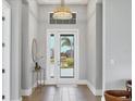 Bright entryway with glass front door and wood floors at 8372 Sea Glass Ct, Sarasota, FL 34240