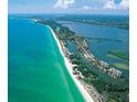 Aerial view showing coastal community, beach, and waterways at 9393 Midnight Pass Rd # 201, Sarasota, FL 34242