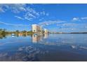 Kayakers paddle in calm waters with condo building reflection at 9393 Midnight Pass Rd # 201, Sarasota, FL 34242