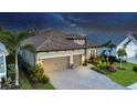 Night-time aerial view of house, showcasing the home's architecture and landscaping at 13325 Indigo Way, Bradenton, FL 34211