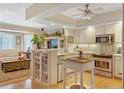 Modern kitchen with stainless steel appliances and light cabinets at 5392 Gulf Dr, Holmes Beach, FL 34217