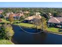 Back of house with pool and water views at 7123 Beechmont Ter, Lakewood Ranch, FL 34202