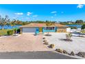 Aerial view of waterfront home with driveway and landscaping at 725 N Manasota Key Rd # A, Englewood, FL 34223