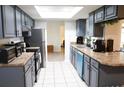 Modern kitchen with stainless steel appliances and gray cabinets at 1416 Glenmere Dr, Brandon, FL 33511