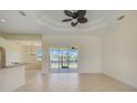 Spacious living area with tile floors,sliding glass doors, and water view at 15124 Leipzig Cir, Port Charlotte, FL 33981