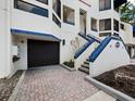 Dark brown garage door and blue tiled stairs at the entrance of the property at 1912 Harbourside Dr # 603, Longboat Key, FL 34228