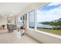 Living room showcasing water views and tiled floors at 3330 Gulf Of Mexico Dr # 205D, Longboat Key, FL 34228