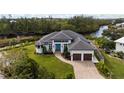 Luxury waterfront home with tile roof and two-car garage at 609 Colonial Bay Dr, Nokomis, FL 34275