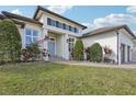 Two-story home with light-colored siding, a three-car garage, and a landscaped yard at 609 Colonial Bay Dr, Nokomis, FL 34275