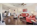 Living room with orange leather couches and dark wood floors at 6100 Greenview Dr # 145, Sarasota, FL 34231