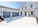 Three-car garage and front entry of a two-story house at 9153 Radiant Cir, Sarasota, FL 34241