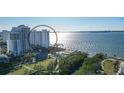 Aerial view of a waterfront high-rise condo with nearby park and water access at 988 Blvd Of The Arts # 915, Sarasota, FL 34236