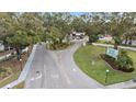 Aerial view of Village Brook community entrance with lush landscaping and parking at 3213 Beneva Rd # 201, Sarasota, FL 34232
