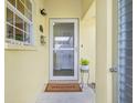 Inviting entryway with a welcome mat and a small plant at 5891 Tidewood Ave # 1, Sarasota, FL 34231