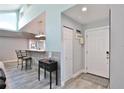 Bright entryway with access to kitchen and coat closet at 8224 Country Oaks Ct, Sarasota, FL 34243