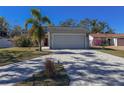 Exterior view of house with palm tree and brick driveway at 8224 Country Oaks Ct, Sarasota, FL 34243