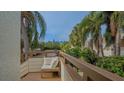 Relaxing balcony with seating area and lush tropical views at 119 Tidewater Dr # 119, Bradenton, FL 34210