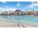 Resort-style pool with lounge chairs and a clubhouse in the background at 16714 Savory Mist Cir, Bradenton, FL 34211