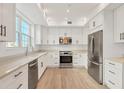 Modern kitchen with stainless steel appliances and white cabinets at 280 Hidden Bay Dr # 201, Osprey, FL 34229