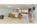 Bright living room featuring a comfy sectional sofa and tiled floors at 3029 Homasassa Rd, Sarasota, FL 34239