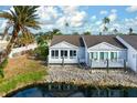 View of the canal-front home with a private deck at 502 Woodstork Cir, Bradenton, FL 34209