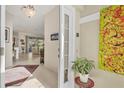 Bright and airy entryway with tile flooring, and a view into the living area at 8472 Gateway Ct, Englewood, FL 34224