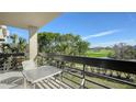 Condo balcony overlooking a lush green golf course and pond at 1065 Gulf Of Mexico Dr # 201, Longboat Key, FL 34228