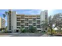 Exterior view of a condo building, showcasing its architecture and landscaping at 1065 Gulf Of Mexico Dr # 201, Longboat Key, FL 34228