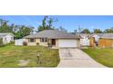 One-story house with a white garage door and green lawn at 161 Sandhurst Dr, Venice, FL 34293