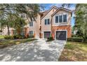 Exterior view of a modern condo featuring a private drive and attached garage at 4178 Central Sarasota Pkwy # 316, Sarasota, FL 34238
