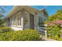 Quaint house entrance with white exterior, landscaping, and white railing at 2525 Ashton Rd, Sarasota, FL 34231