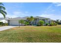 Well-maintained single-story house with a lush green lawn at 5755 Carriage Dr, Sarasota, FL 34243