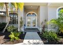 Elegant front entry with double doors and sidelights at 5755 Carriage Dr, Sarasota, FL 34243