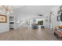 Open-concept living area with hardwood floors and modern lighting at 5755 Carriage Dr, Sarasota, FL 34243