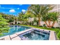 Relaxing pool and spa with lush tropical landscaping at 6506 Gulf Dr, Holmes Beach, FL 34217