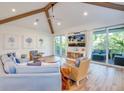 Spacious living area with access to a private balcony and hardwood floors at 9403 Gulf Dr, Anna Maria, FL 34216