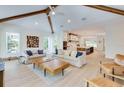 Open living space with hardwood floors, exposed beams, and comfortable seating at 9407 Gulf Dr, Anna Maria, FL 34216