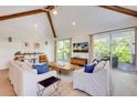 Light-filled living area with sliding doors to a balcony at 9407 Gulf Dr, Anna Maria, FL 34216