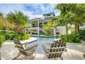 Inviting pool area with lounge chairs, surrounded by tropical landscaping at 9407 Gulf Dr, Anna Maria, FL 34216