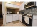 Updated kitchen with stainless steel appliances and mosaic backsplash at 1709 Pelican Cove Rd # Gl445, Sarasota, FL 34231