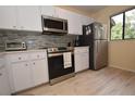 Modern kitchen featuring stainless steel appliances and a stylish backsplash at 1709 Pelican Cove Rd # Gl445, Sarasota, FL 34231