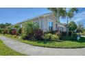 Well-maintained home with lush landscaping and a paved walkway at 5433 Hope Sound Cir, Sarasota, FL 34238