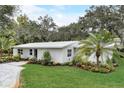 White single story home with landscaped yard and palm trees at 730 40Th St, Sarasota, FL 34234