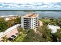 Aerial view of waterfront condo building with parking and pool at 8701 Midnight Pass Rd # 106A, Sarasota, FL 34242