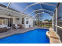 Beautiful screened-in pool area with outdoor seating and access to the home's interior, perfect for entertaining at 12147 Maple Ridge Dr, Parrish, FL 34219