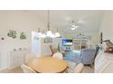 Casual dining area with wood table and chairs, adjacent to living room at 1302 58Th W St, Bradenton, FL 34209