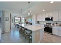Spacious kitchen with island, stainless steel appliances, and white cabinets at 1010 Tidewater Shores Loop # 103, Bradenton, FL 34208