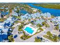 Aerial view showing community pool and surrounding buildings at 1325 Siesta Bayside Dr # 1325B, Sarasota, FL 34242