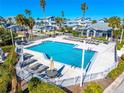 Community pool with lounge chairs and patio area at 1325 Siesta Bayside Dr # 1325B, Sarasota, FL 34242