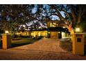 Elegant two-story home with a landscaped yard and brick driveway at 1827 Baywood Dr, Sarasota, FL 34231